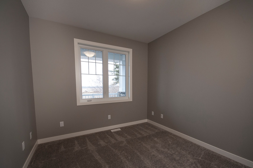 Photo of a medium sized modern guest bedroom in Calgary with grey walls, carpet and beige floors.