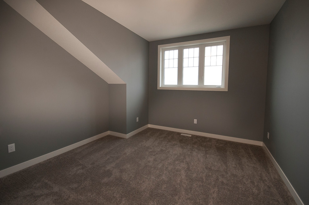 Example of a mid-sized minimalist guest carpeted and beige floor bedroom design in Calgary with gray walls