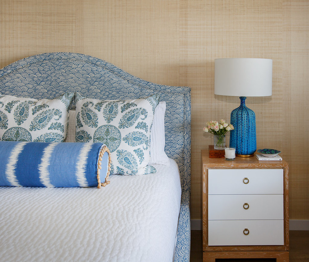 Large beach style master bedroom in Jacksonville with beige walls and medium hardwood flooring.