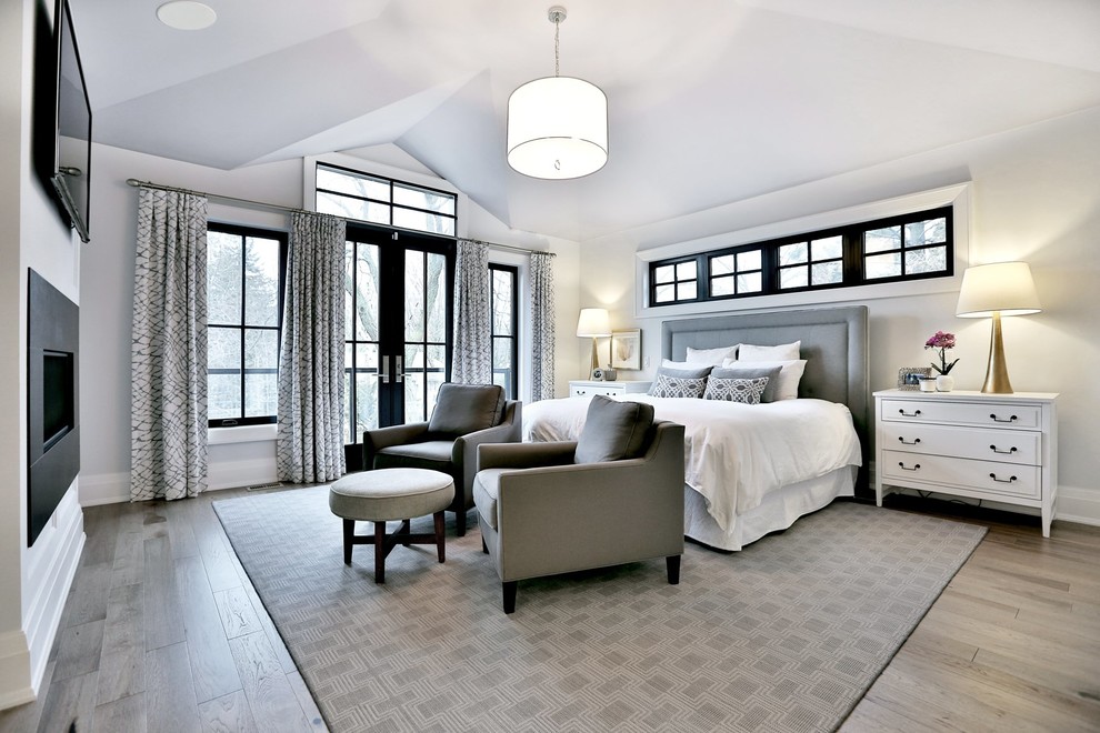 Пример оригинального дизайна: хозяйская спальня среднего размера в стиле неоклассика (современная классика) с белыми стенами, светлым паркетным полом и горизонтальным камином