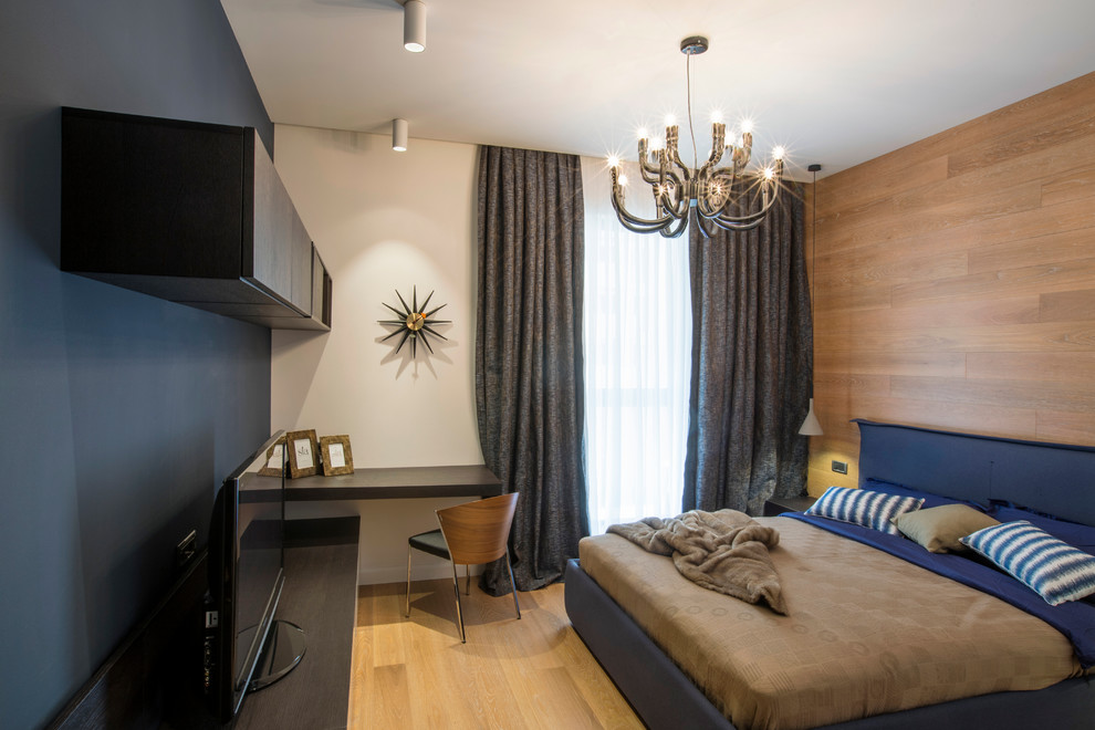 Small minimalist master medium tone wood floor bedroom photo in Other with blue walls