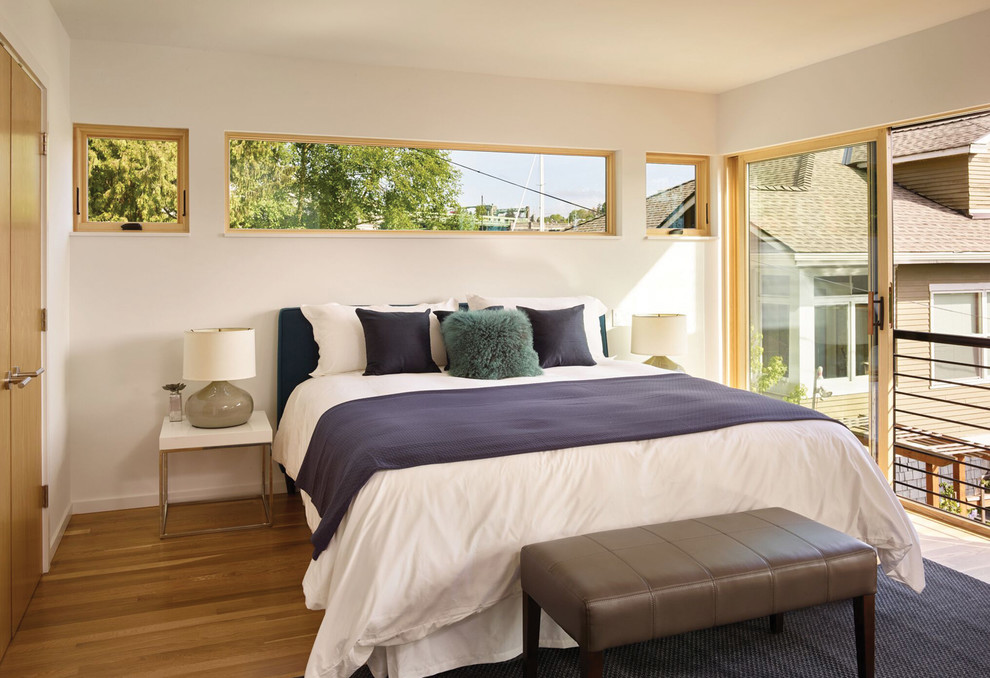 Design ideas for a scandi master bedroom in Seattle with white walls, light hardwood flooring and no fireplace.