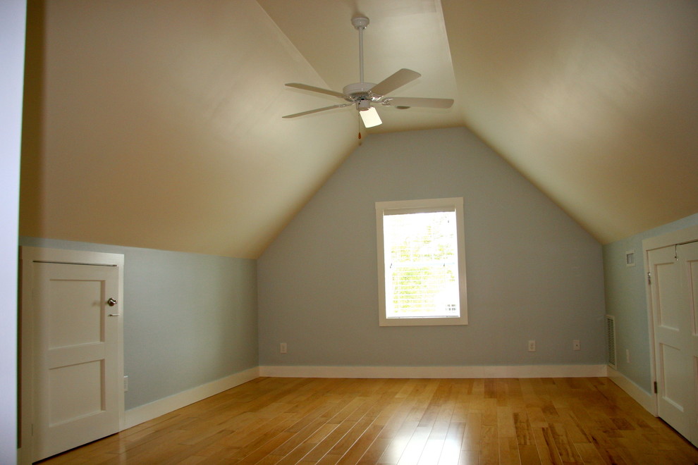 Mid-sized elegant loft-style light wood floor and beige floor bedroom photo in Wilmington with blue walls