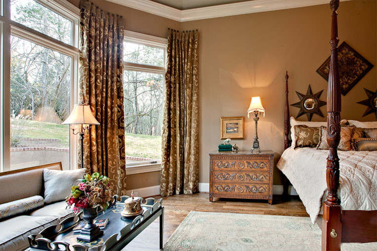 Bedroom - large traditional master medium tone wood floor bedroom idea in Nashville with beige walls
