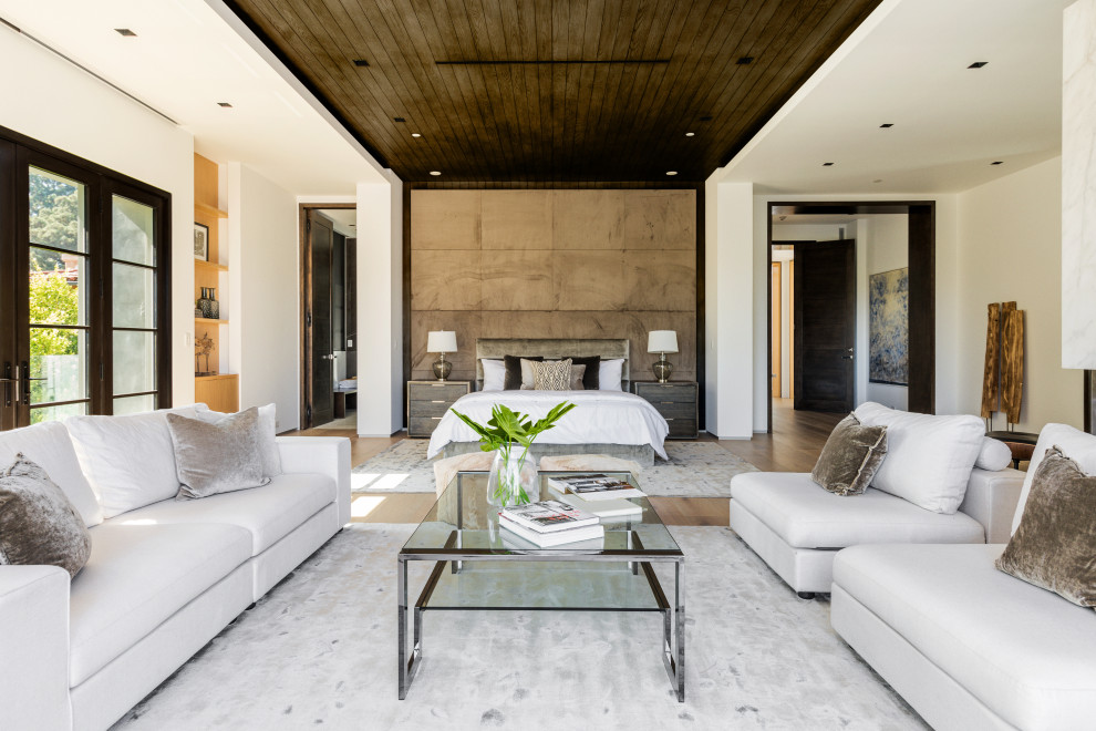 Inspiration for a contemporary medium tone wood floor, brown floor and wood ceiling bedroom remodel in Los Angeles with white walls
