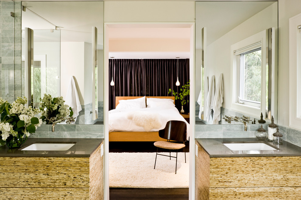 Example of a mid-century modern bedroom design in Portland with white walls