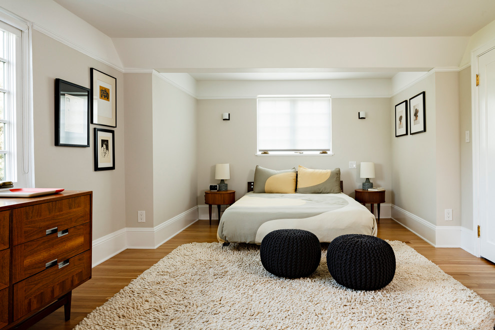 Bedroom - mid-sized contemporary master medium tone wood floor bedroom idea in Portland with beige walls