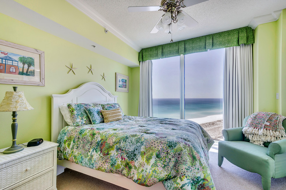Coastal bedroom in Miami with green walls and carpet.