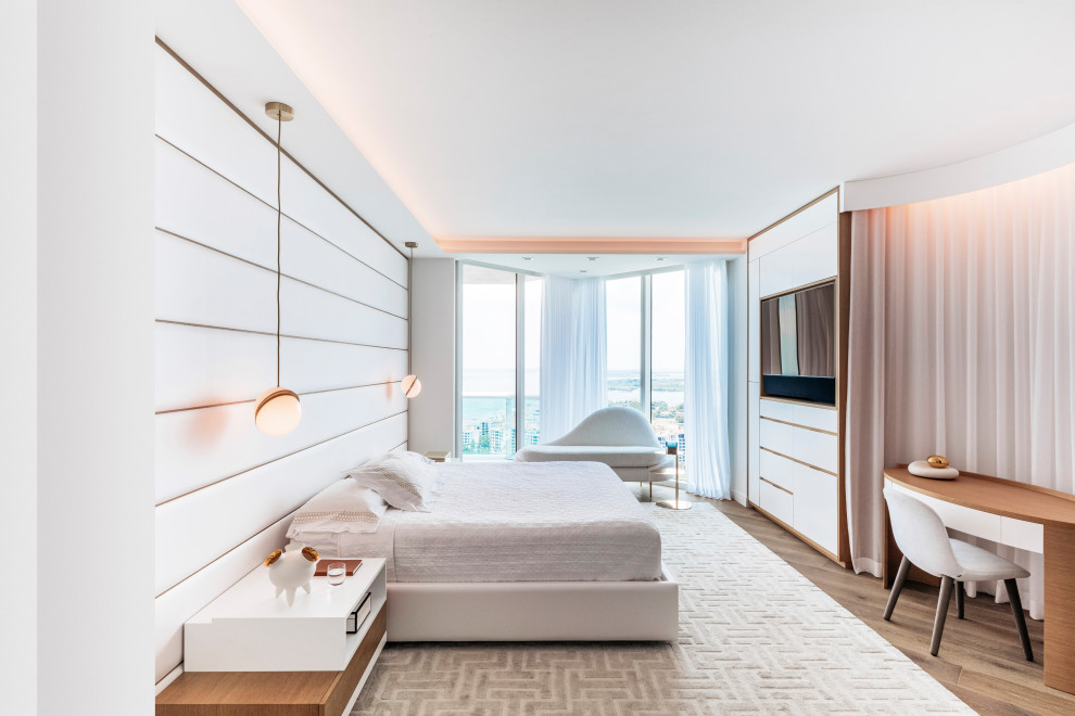 Modernes Schlafzimmer ohne Kamin mit weißer Wandfarbe, braunem Holzboden und braunem Boden in Miami
