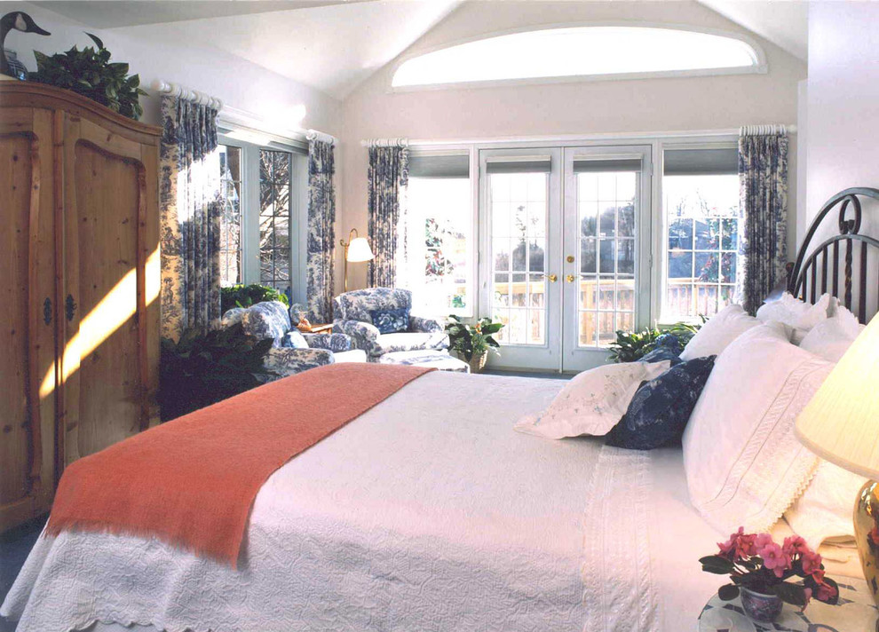 Example of a mid-sized trendy master carpeted bedroom design in Manchester with white walls and no fireplace