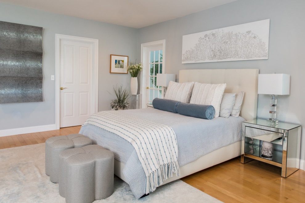 Medium sized traditional master bedroom in Boston with light hardwood flooring, orange floors and blue walls.