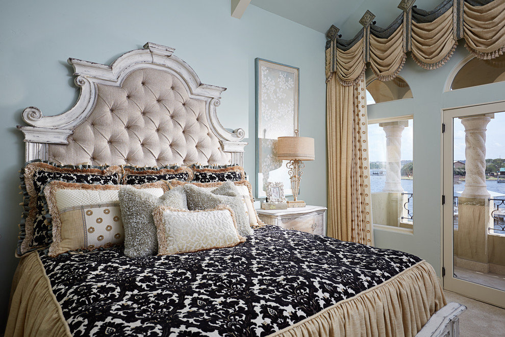 This is an example of a large mediterranean guest bedroom in Dallas with blue walls and carpet.