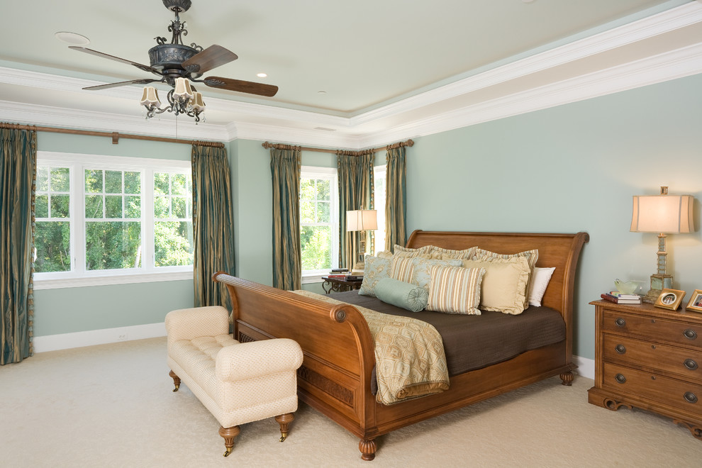 Photo of a classic master bedroom in DC Metro with blue walls and carpet.