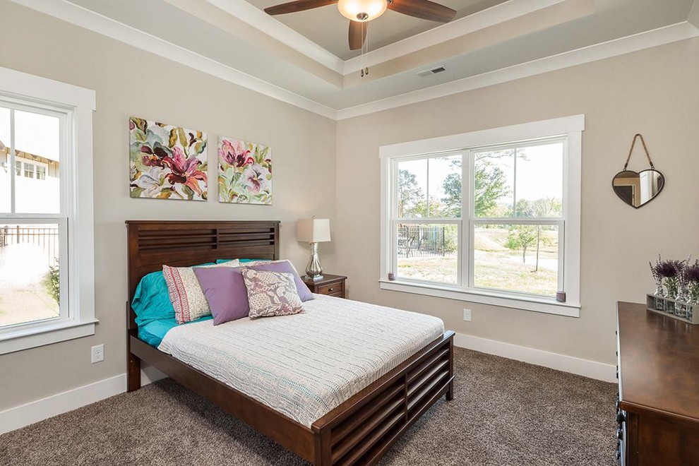 Small classic guest bedroom in Other with beige walls and carpet.