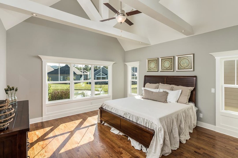 Bedroom - large traditional medium tone wood floor bedroom idea in Other with gray walls