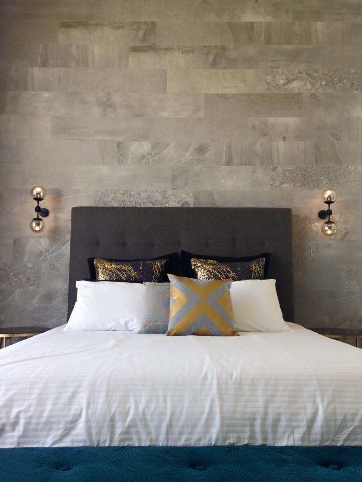 Large modern master bedroom in Adelaide with grey walls, medium hardwood flooring and brown floors.