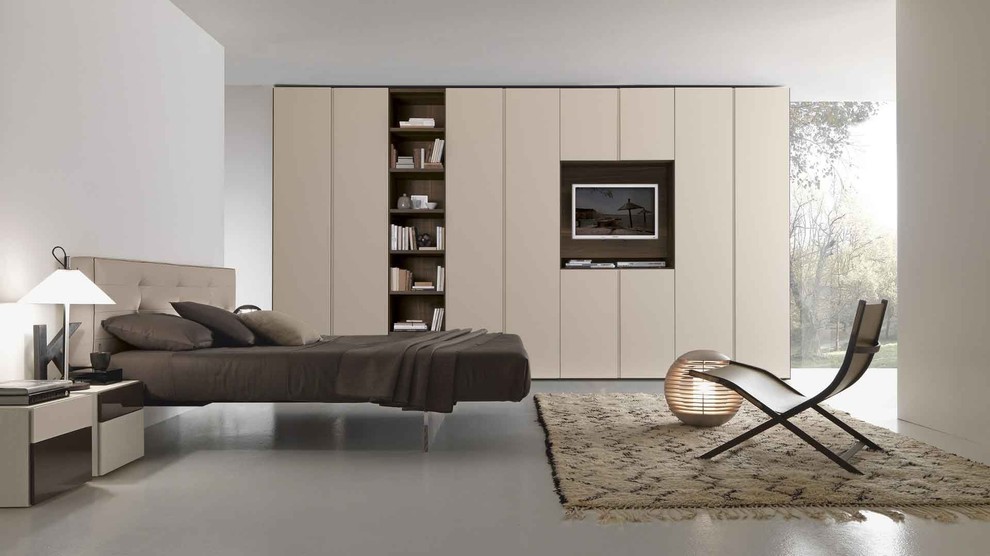 Idée de décoration pour une chambre minimaliste de taille moyenne avec sol en béton ciré et un sol gris.