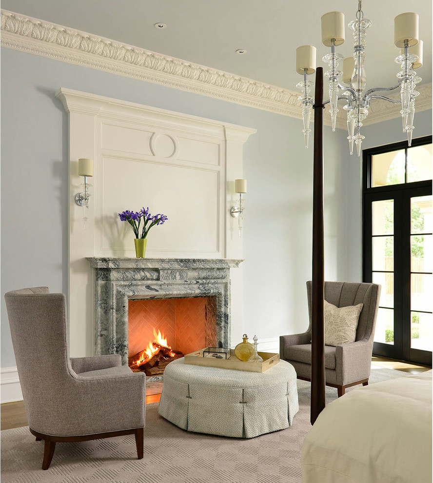 Example of a large classic master dark wood floor and brown floor bedroom design in Dallas with blue walls, a standard fireplace and a stone fireplace