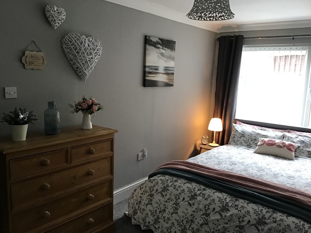 Inspiration for a medium sized vintage guest and grey and pink bedroom in Cheshire with grey walls, carpet, no fireplace and grey floors.