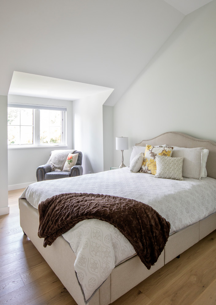 Photo of a medium sized rustic guest bedroom in Vancouver with white walls, medium hardwood flooring and brown floors.