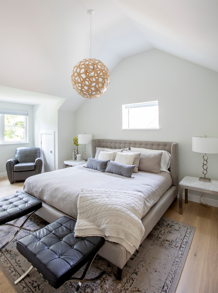 Photo of a medium sized contemporary master bedroom in Vancouver with white walls, medium hardwood flooring and beige floors.