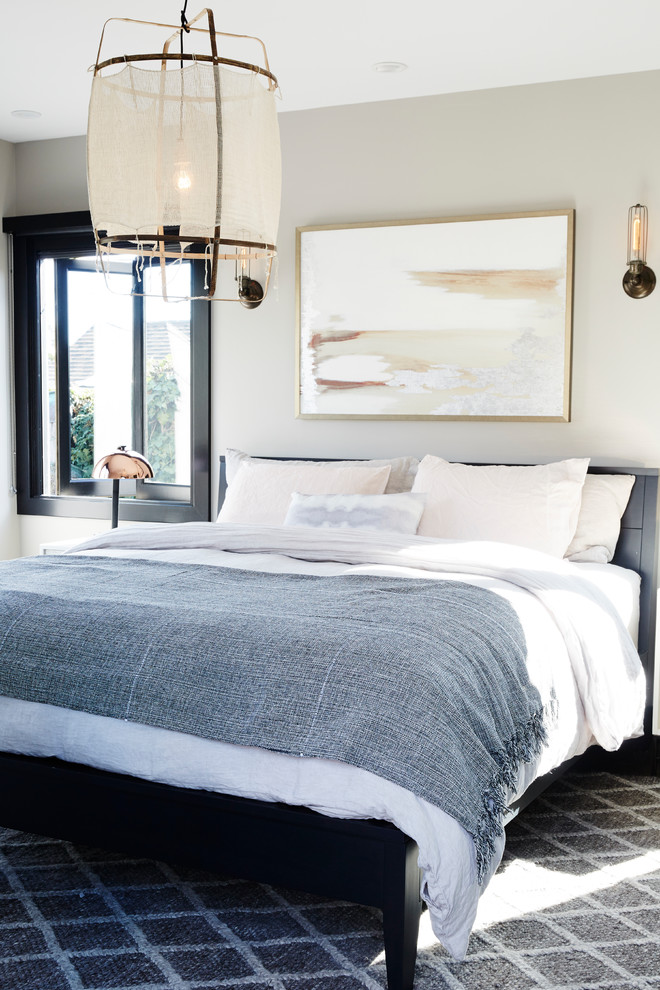 Example of a beach style master bedroom design in Los Angeles with gray walls