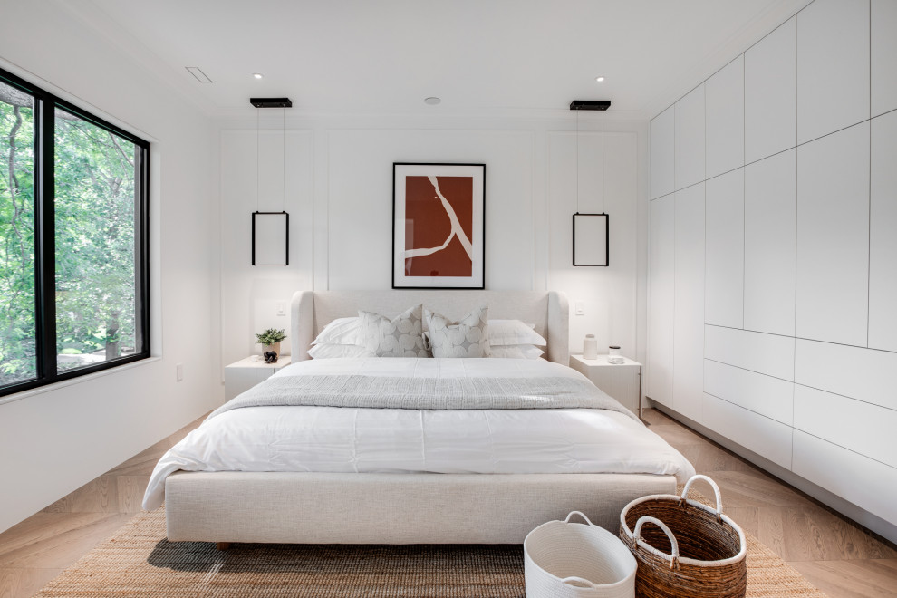 Example of a mid-sized trendy master light wood floor, beige floor and wall paneling bedroom design in Toronto with white walls