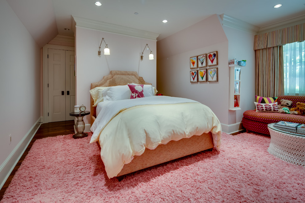 Example of a large farmhouse guest medium tone wood floor bedroom design in DC Metro with pink walls