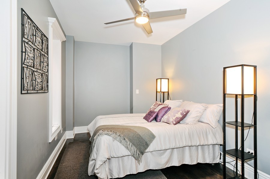 Bedroom - mid-sized modern guest dark wood floor bedroom idea in Chicago with gray walls