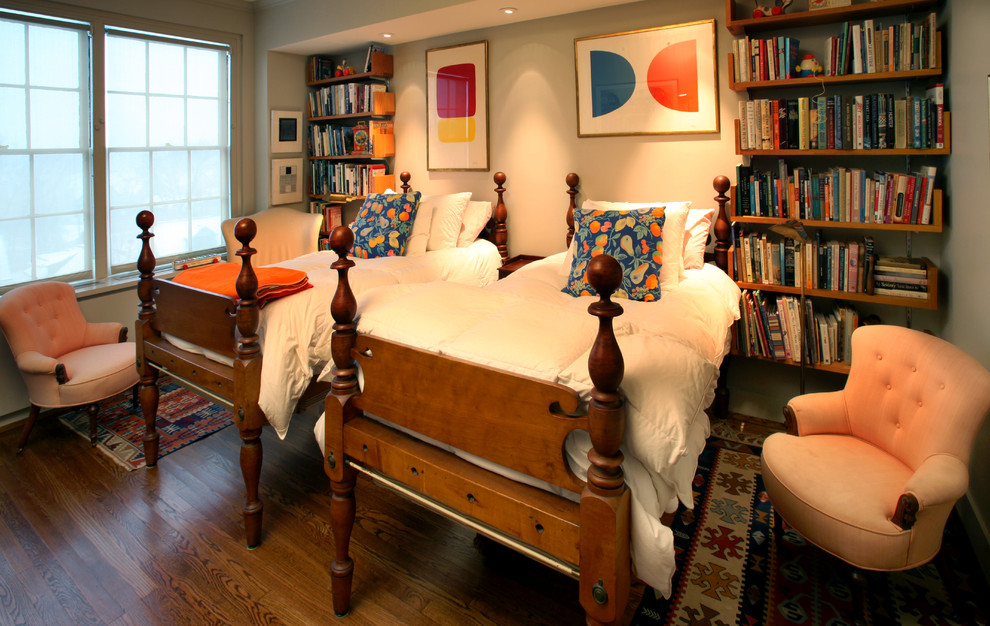 Example of a guest medium tone wood floor bedroom design in New York with beige walls