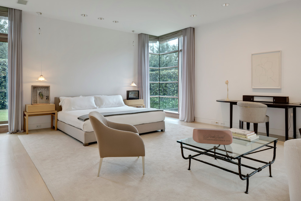 This is an example of a large modern guest bedroom in Dallas with white walls, limestone flooring and no fireplace.