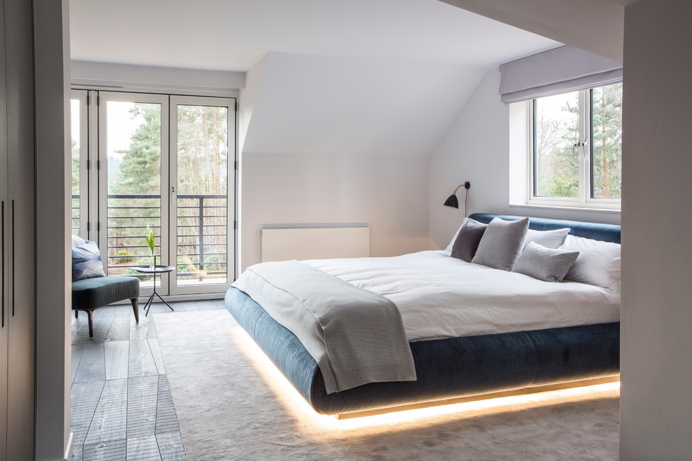 Photo of a contemporary bedroom in Surrey with white walls.