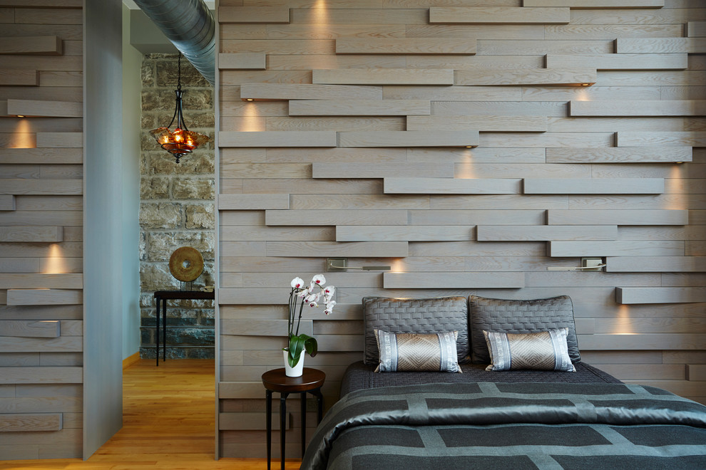 Example of a small urban master medium tone wood floor bedroom design in Minneapolis with brown walls