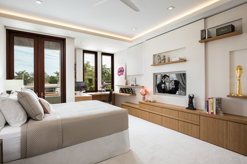 Imagen de dormitorio principal y televisión costero extra grande sin chimenea con moqueta, suelo beige y paredes beige