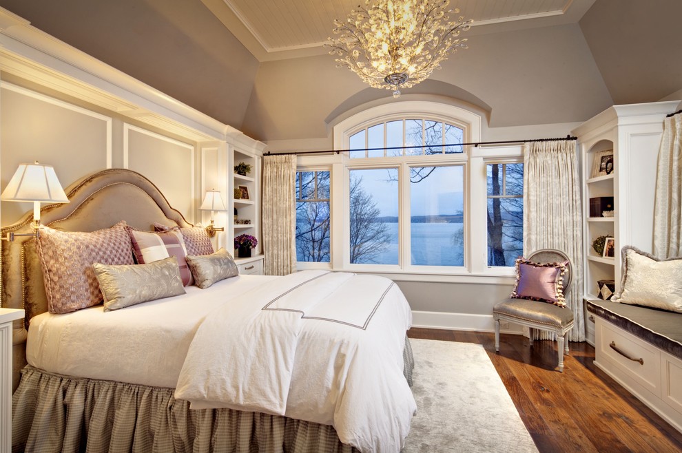 Inspiration for a large timeless master medium tone wood floor bedroom remodel in Milwaukee with beige walls and no fireplace