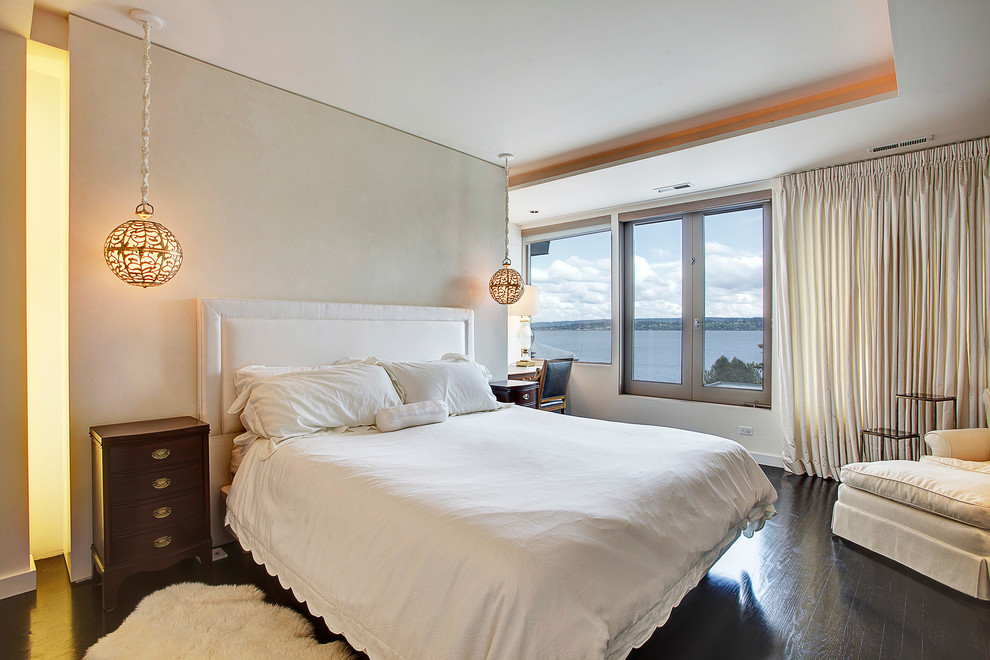 Inspiration for a contemporary bedroom in Seattle with beige walls and dark hardwood flooring.