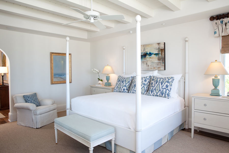 Inspiration for a medium sized beach style master bedroom in Jacksonville with white walls, dark hardwood flooring, no fireplace and brown floors.