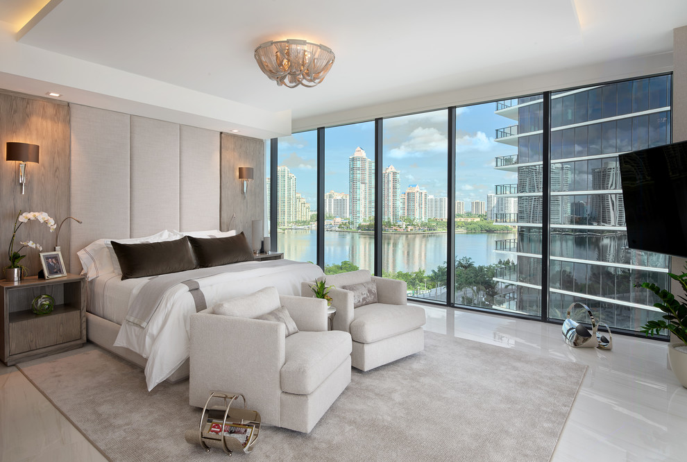 Contemporary bedroom in Miami with white walls and white floors.