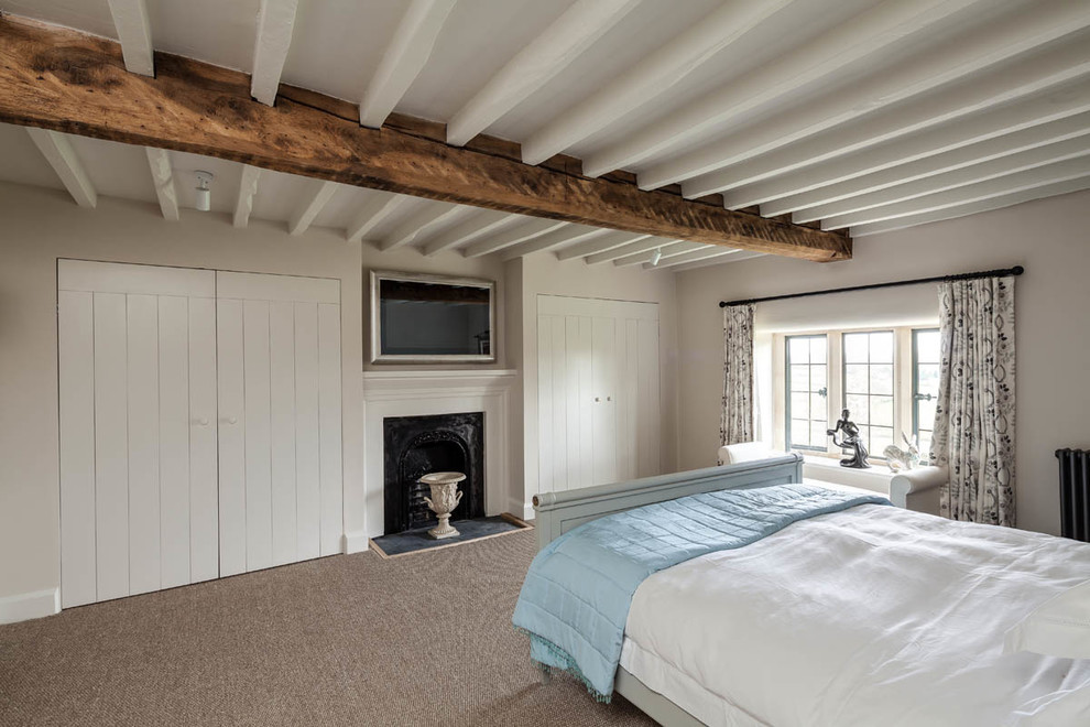 Example of a farmhouse carpeted bedroom design in Gloucestershire