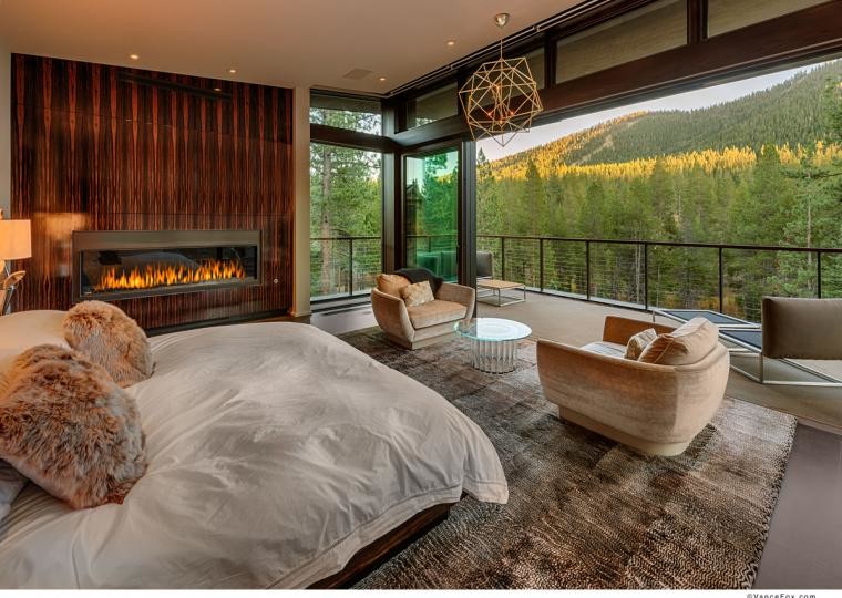 Bedroom - large contemporary master concrete floor bedroom idea in Sacramento with white walls, a ribbon fireplace and a wood fireplace surround