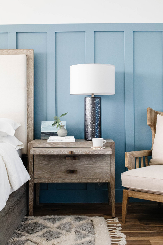 Design ideas for a large beach style master bedroom in Other with blue walls and wainscoting.