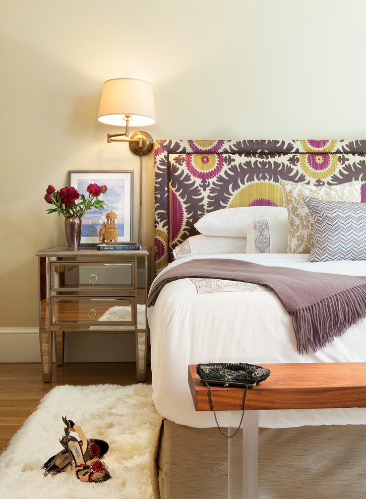 Example of a trendy medium tone wood floor bedroom design in Boston with beige walls
