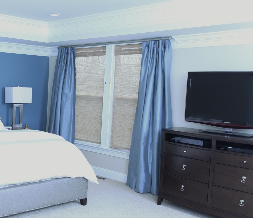 This is an example of a large classic master bedroom in Orlando with blue walls, carpet and no fireplace.