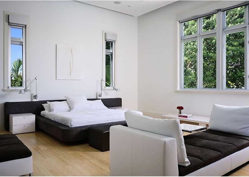 Inspiration for a large contemporary master bamboo floor bedroom remodel in Miami with white walls and no fireplace