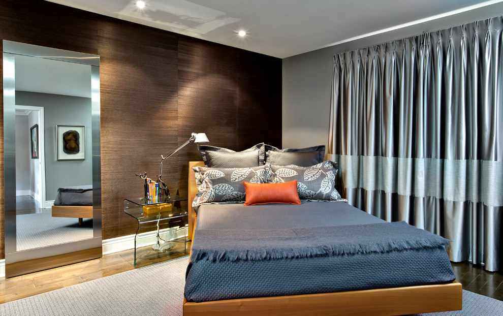 Large contemporary master bedroom in Montreal with grey walls and dark hardwood flooring.