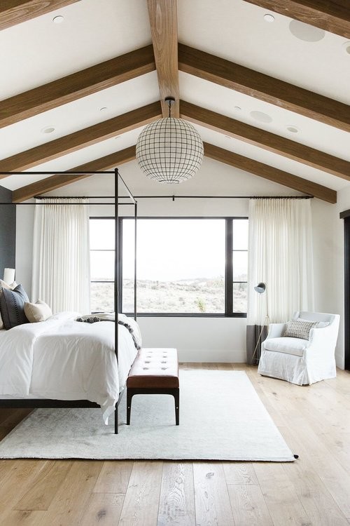 Photo of a medium sized eclectic master bedroom in Salt Lake City with white walls and medium hardwood flooring.