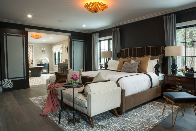 Large transitional master medium tone wood floor and brown floor bedroom photo in Los Angeles with black walls, a ribbon fireplace and a tile fireplace