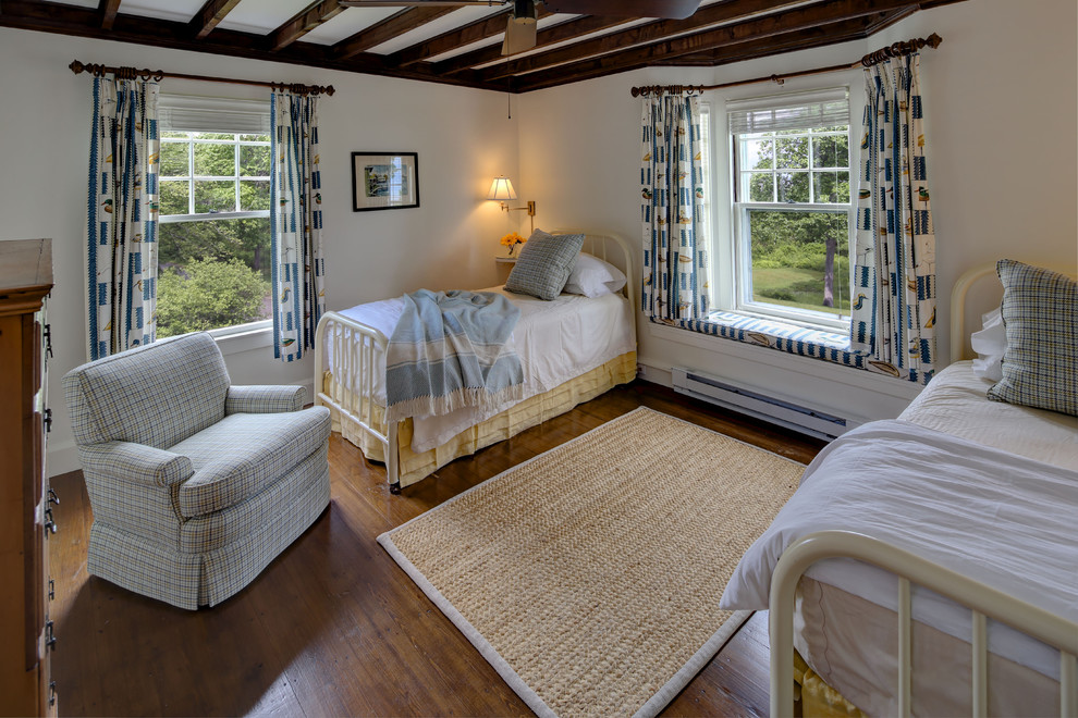 This is an example of a medium sized traditional guest bedroom in Portland Maine with white walls, medium hardwood flooring and no fireplace.