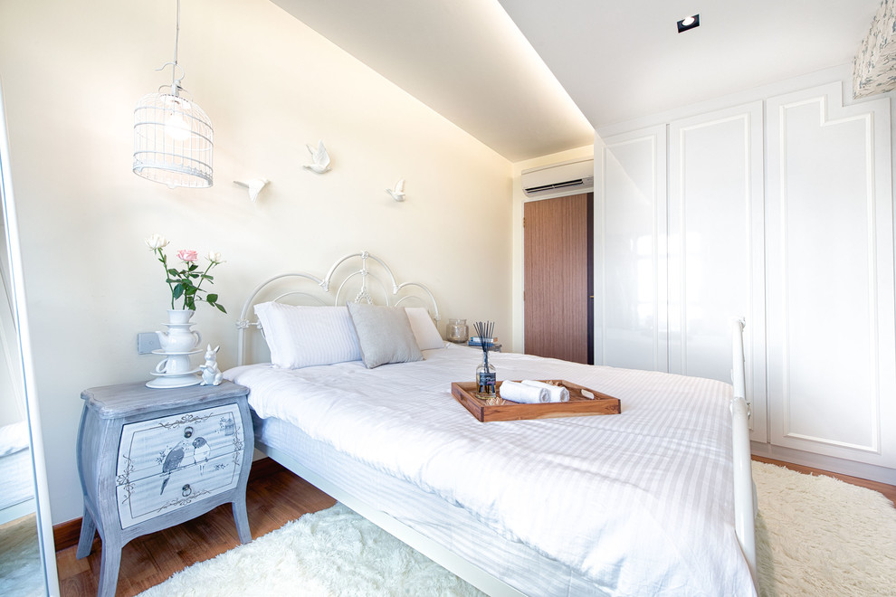 Inspiration for a small contemporary master bedroom in Singapore with white walls and dark hardwood flooring.