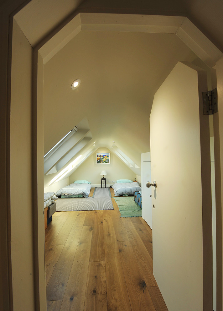 Contemporary bedroom in London with dark hardwood flooring.